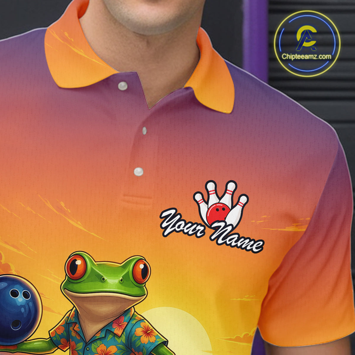 A close-up of a person wearing a short-sleeve polo shirt with a purple-to-orange gradient background and a green frog wearing a floral shirt, alongside a bowling ball and bowling pins graphic. 
