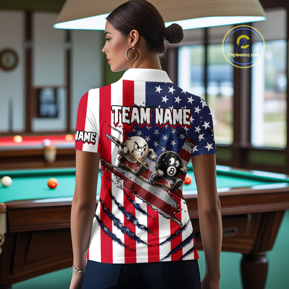 A woman stands in a billiards room wearing a custom short-sleeve polo shirt with a patriotic American flag design, featuring cartoon billiards characters and the text 'TEAM NAME' on the back.