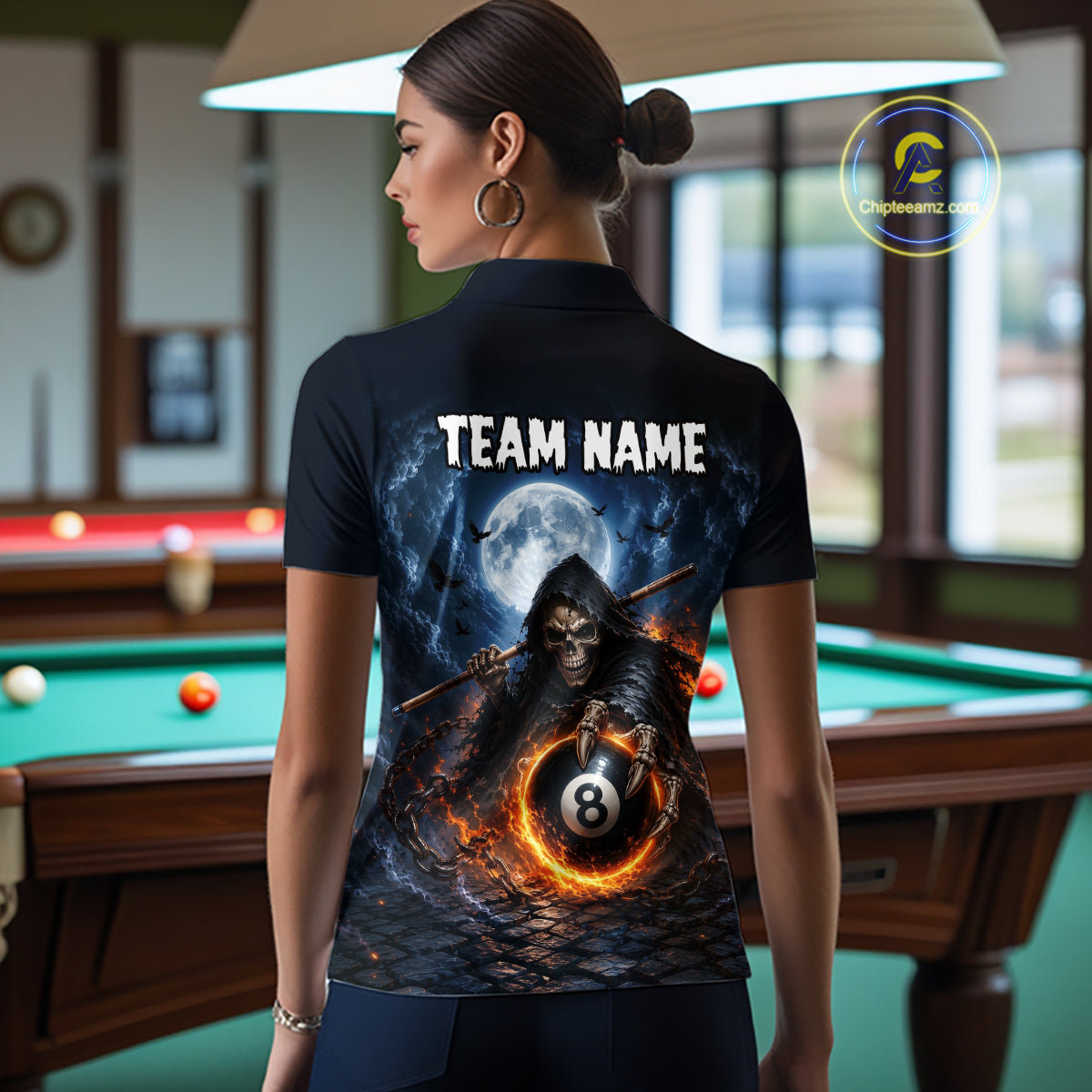 A woman stands with her back to the camera wearing a black short-sleeve polo shirt with a large graphic print on the back. The print shows a grim reaper holding a 8-ball under a full moon, with the text 'TEAM NAME' above.