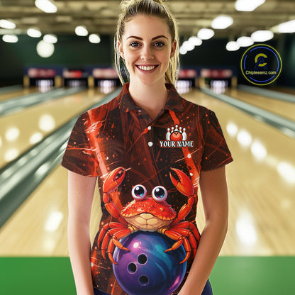 Person wearing a custom bowling shirt with a crab design in a bowling alley.