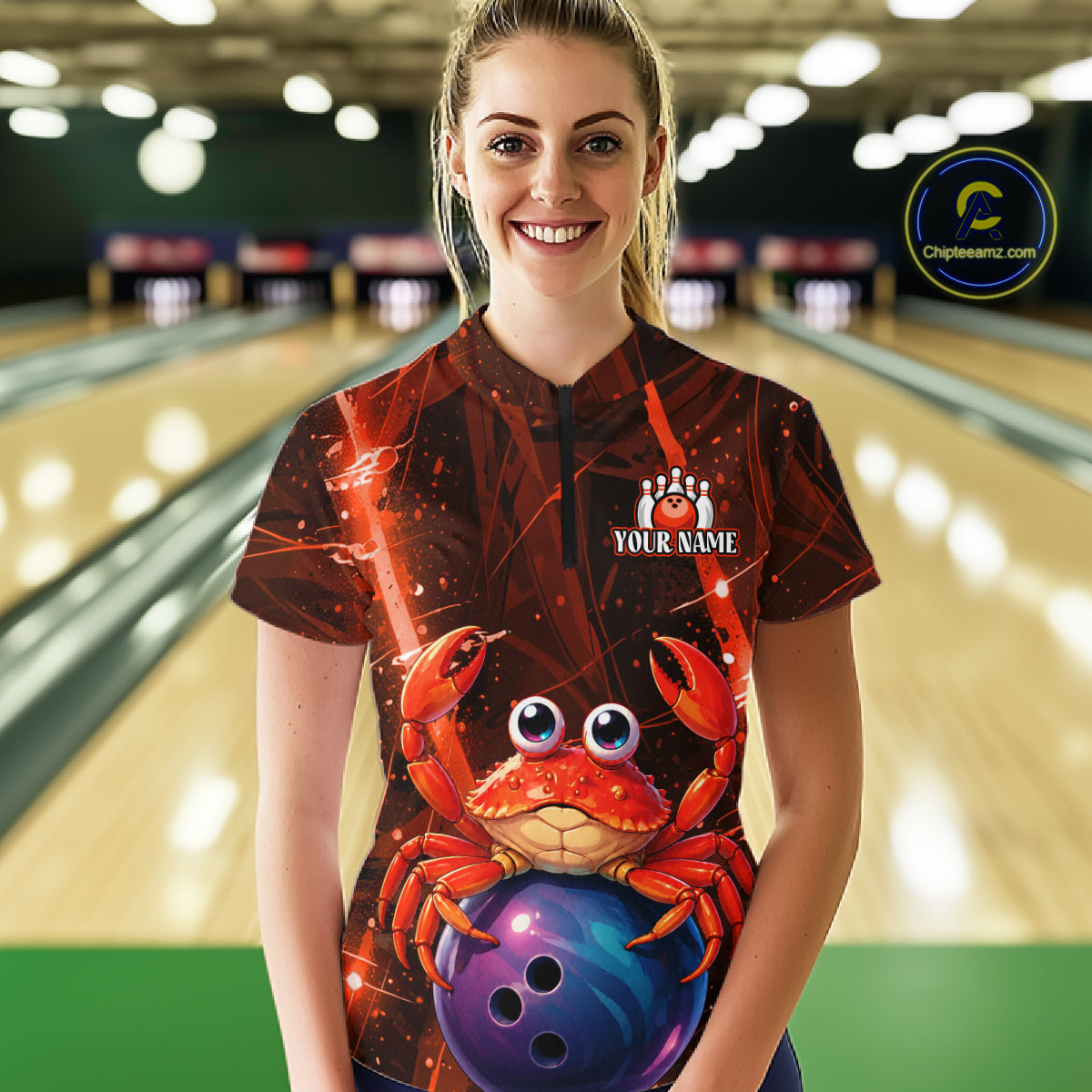 Person wearing a custom bowling shirt with a red crab design in a bowling alley.
