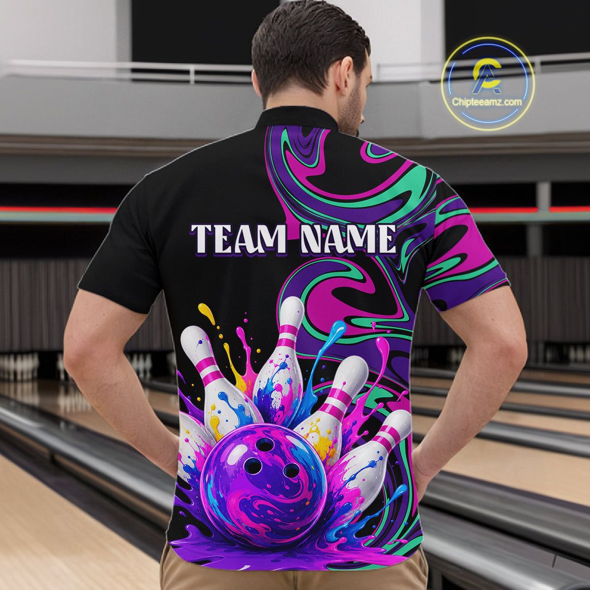 Person wearing a colorful bowling-themed shirt with 'TEAM NAME' text in a bowling alley.