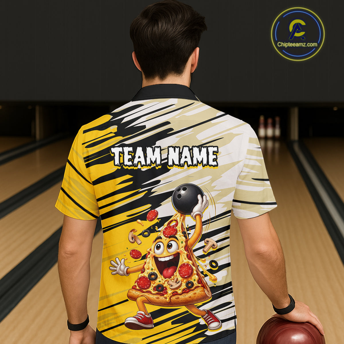 Person wearing a bowling-themed shirt with a pizza character and 'TEAM NAME' text, standing on a bowling lane.