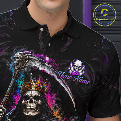 A close-up of a person wearing a black polo shirt with a large graphic print featuring a grim reaper skull with a gold crown, a scythe, purple and blue smoke effects, and a customizable skull logo with the text 'Your Name'. 