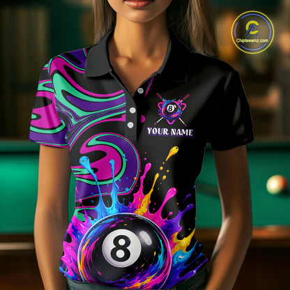 A woman wearing a black short-sleeve polo shirt with a vibrant, colorful 3D-printed design featuring a large 8-ball pool cue graphic and neon paint splatters. 