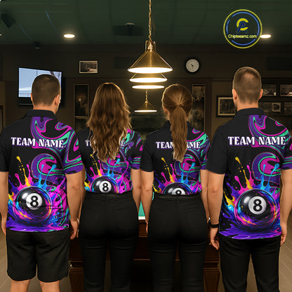 Four people standing with their backs to the camera in a dimly lit billiards room, wearing matching black short-sleeve shirts with a vibrant purple, blue, and pink 8-ball themed graphic print and 'TEAM NAME' text on the back.
