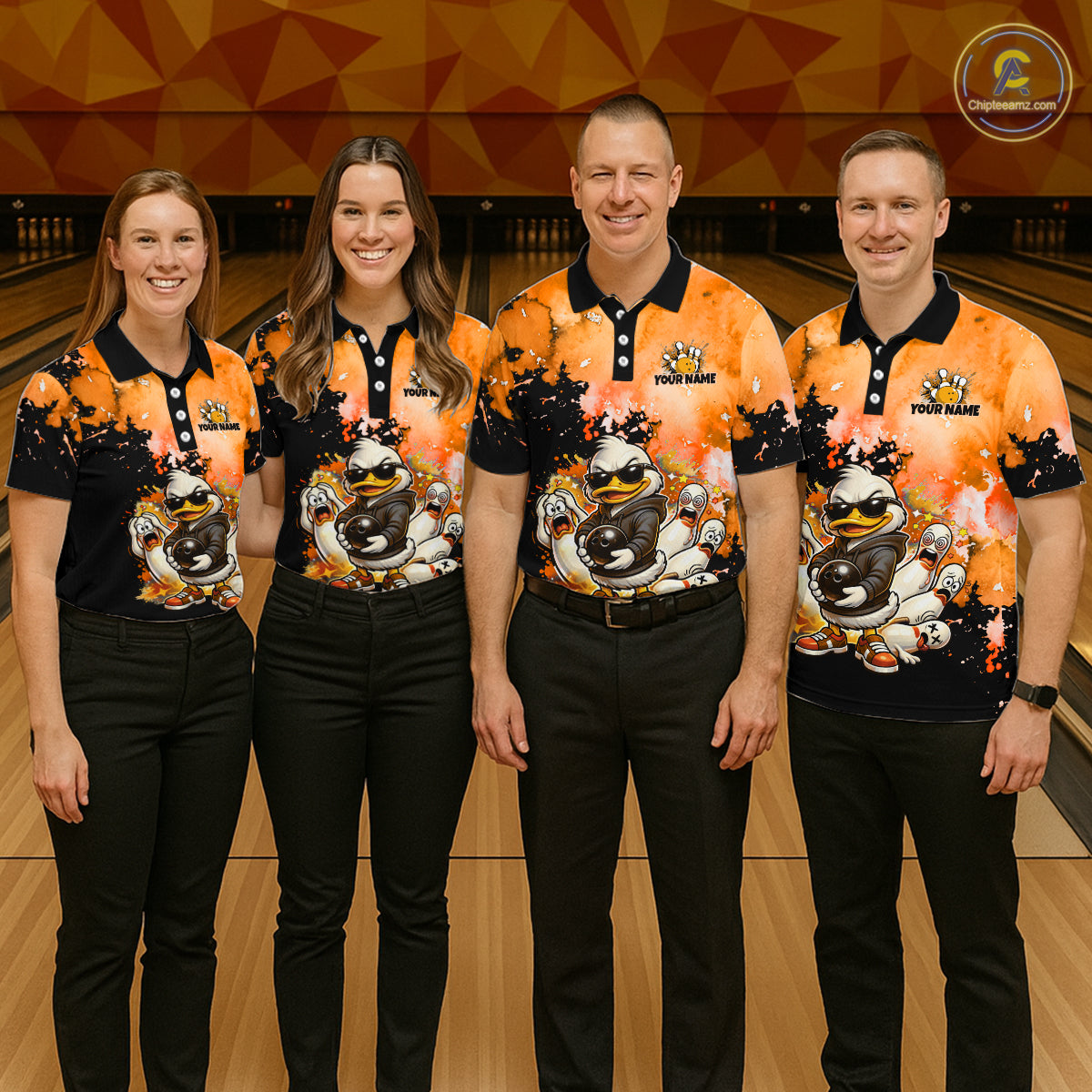 Four people standing in a bowling alley wearing matching orange and black bowling-themed polo shirts with a cartoon character graphic, paired with black pants.