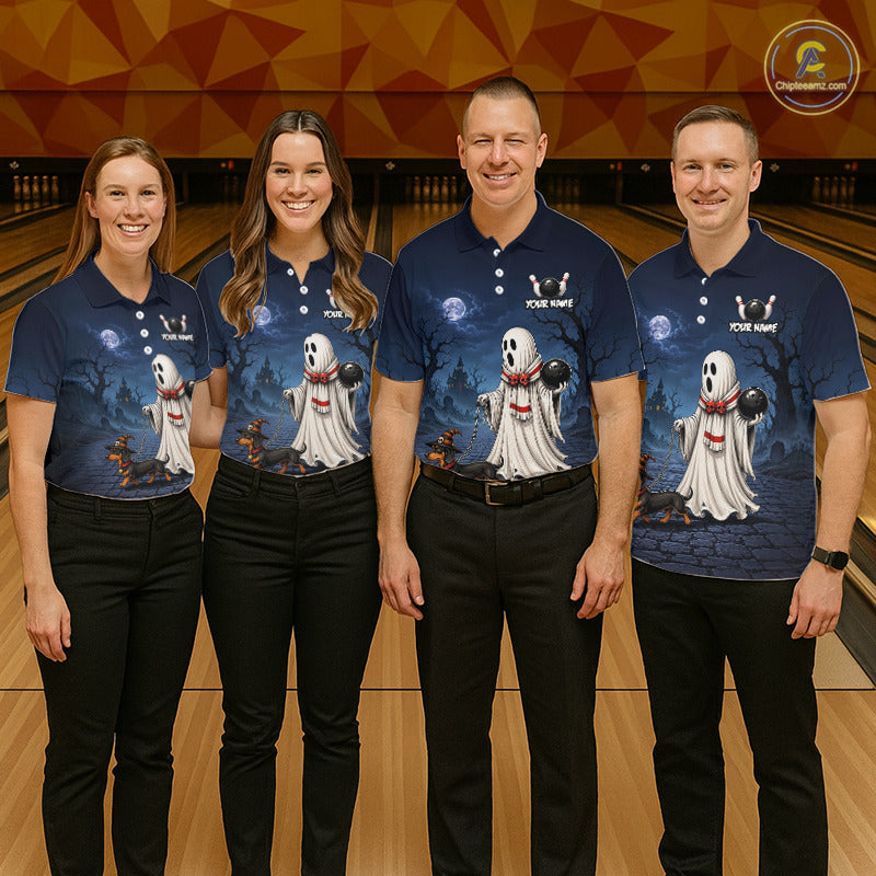 Four people standing together in a bowling alley wearing matching navy blue polo shirts with a Halloween ghost graphic and black pants. The shirts feature a white ghost illustration with a red bow tie and the text 'YOUR NAME'.