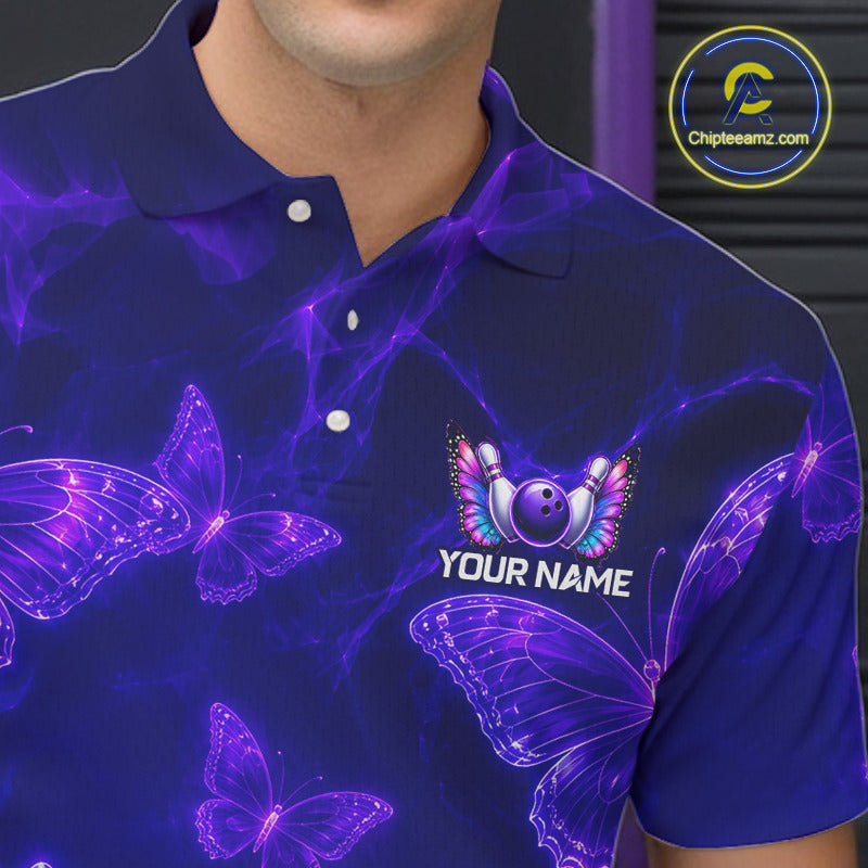 A close-up of a man wearing a dark blue polo shirt with a purple and pink glowing butterfly pattern and a custom graphic on the chest featuring a bowling pin and the text 'YOUR NAME'.