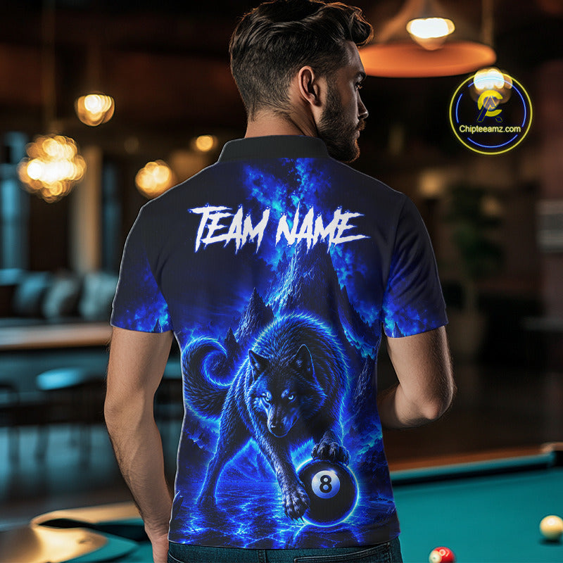 A man viewed from behind wearing a custom short-sleeve polo shirt with a vibrant blue and black wolf graphic holding an 8-ball, with 'TEAM NAME' printed in white across the upper back. The background shows a blurred pool hall environment with a green pool table.