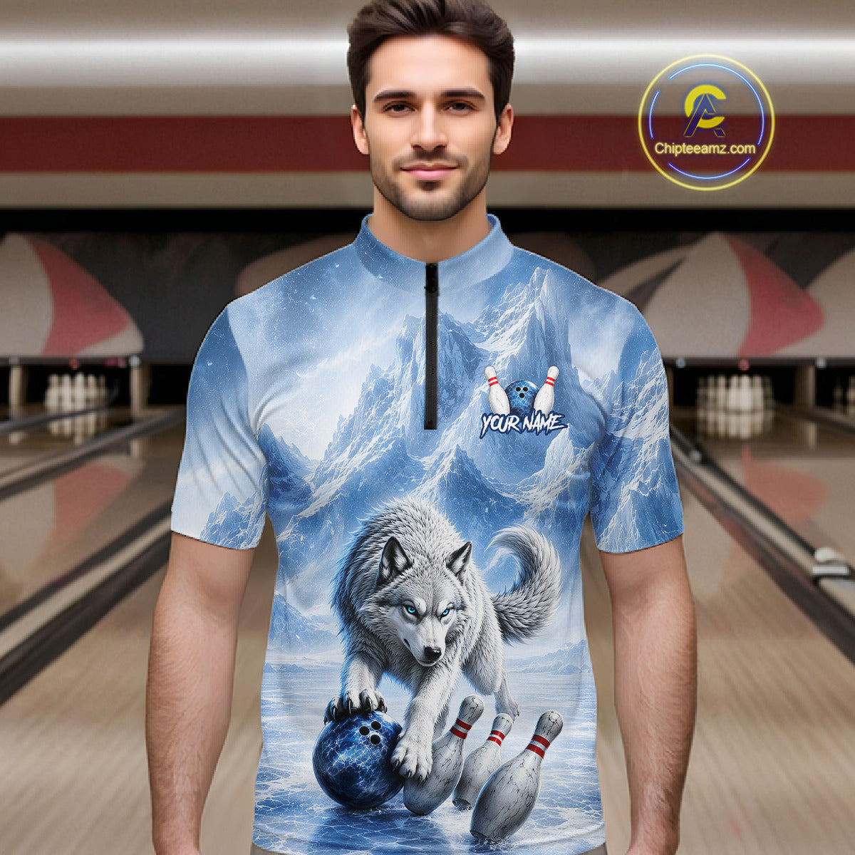 Man wearing a shirt with a wolf and bowling ball design in a bowling alley.