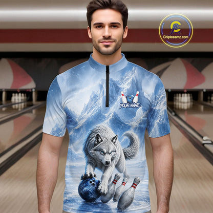 Man wearing a shirt with a wolf and bowling ball design in a bowling alley.