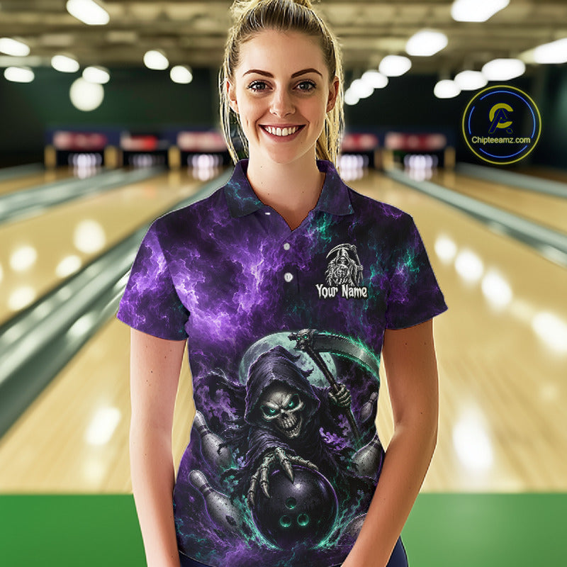 A woman stands in a bowling alley wearing a short-sleeve polo shirt with a dark purple and black cosmic/spooky graphic print featuring a grim reaper and bowling ball. The shirt has a white custom name print on the chest.