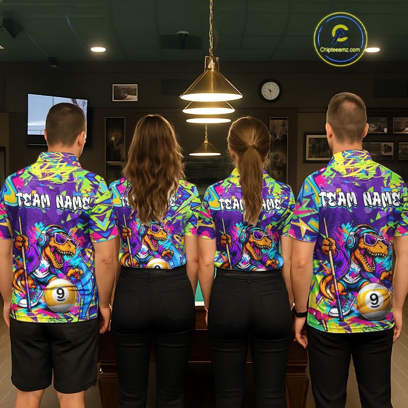 Four people wearing graffiti dinosaur shirts with a team name on the back in a bowling alley.