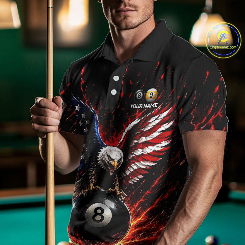 Person wearing a black polo shirt with an eagle and pool ball design, holding a pool cue in a billiards setting.