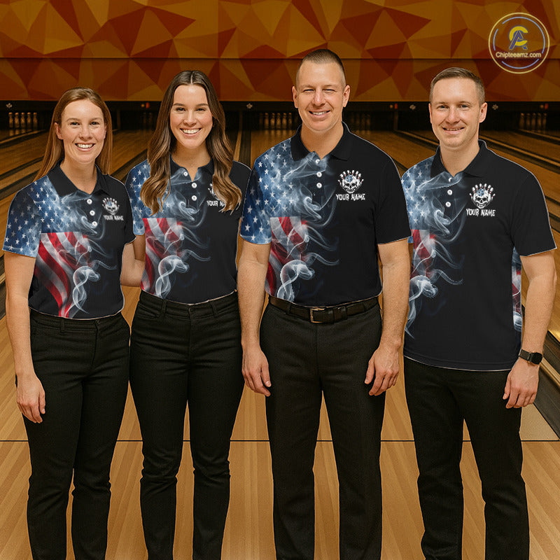 Four people standing together in a bowling alley wearing matching dark navy polo shirts with a patriotic American flag and smoke graphic design, paired with black pants.