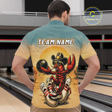 Load image into Gallery viewer, Man wearing a shirt with a colorful design of a crawfish in a cowboy hat and boots, standing in back of a bowling alley.