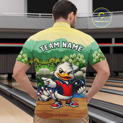 Person wearing a bowling-themed shirt with a cartoon character in a bowling alley.