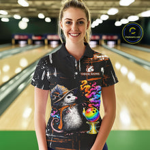 Load image into Gallery viewer, A woman stands in a bowling alley wearing a black short-sleeve polo shirt with a colorful graphic print featuring a hedgehog, bowling balls, bowling pins, and the text 'YOUR NAME' 