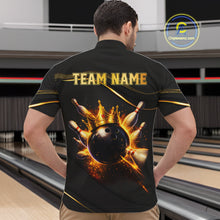 Load image into Gallery viewer, Man wearing custom black gold bowling quarter-zip shirt back view featuring a fiery bowling ball and flame burst effect, displaying Team Name, at the bowling alley