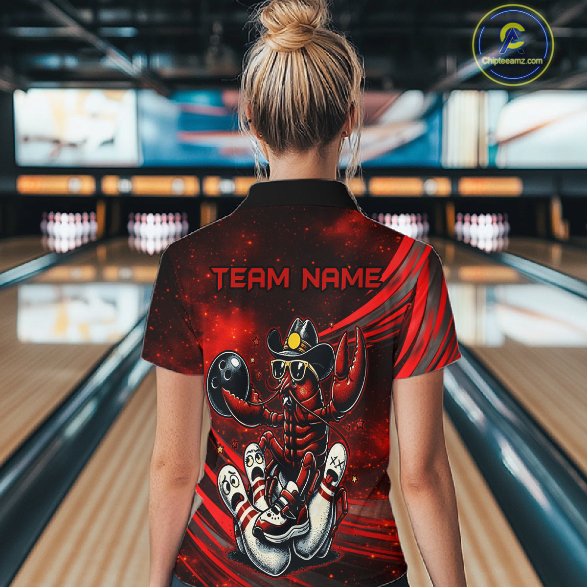 Person wearing a red and black shirt with a crawfish design and 'TEAM NAME' text in a bowling alley.