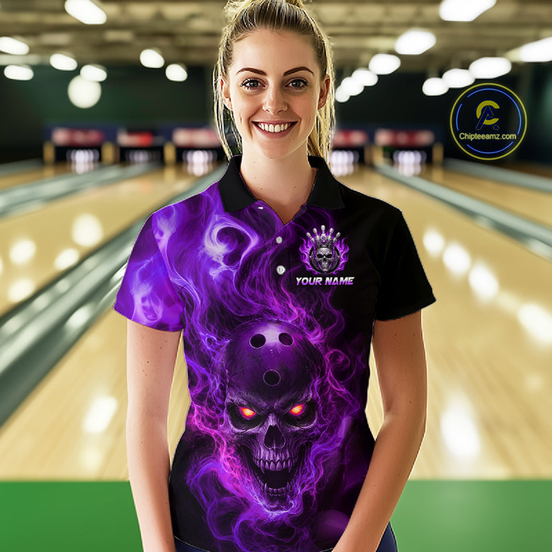 Woman wearing a black bowling polo shirt featuring a flaming skull with glowing orange eyes, purple smoke effects, and custom “YOUR NAME” text