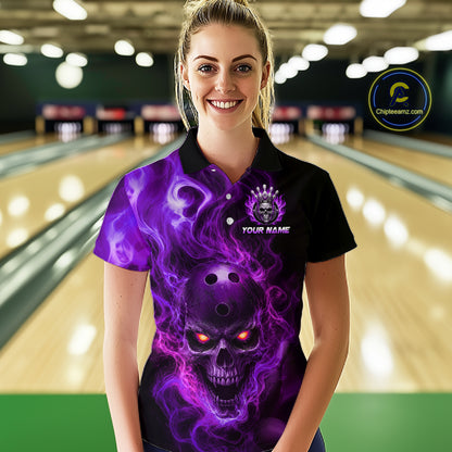 Woman wearing a black bowling polo shirt featuring a flaming skull with glowing orange eyes, purple smoke effects, and custom “YOUR NAME” text