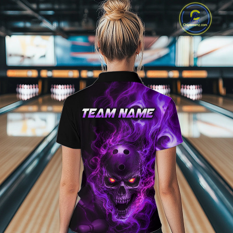 Woman wearing a black bowling polo shirt featuring a flaming skull with glowing orange eyes, purple smoke effects, and custom “TEAM NAME” 