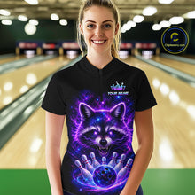 Load image into Gallery viewer, A woman stands in a bowling alley wearing a black short-sleeve bowling shirt with a large purple and blue cosmic raccoon graphic on the front. The shirt has a mock logo and the text 'YOUR NAME'.