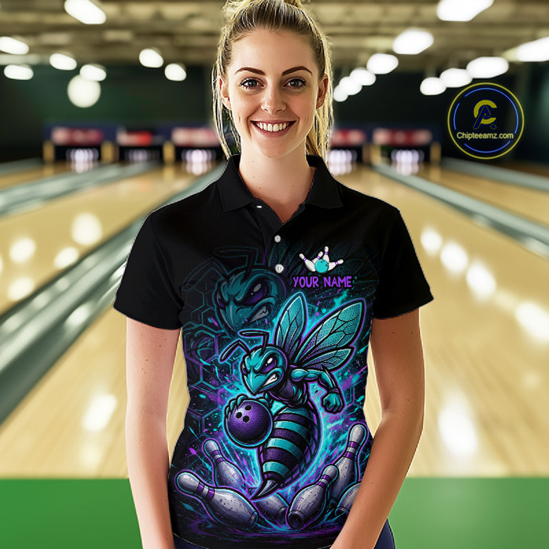 Woman wearing a black bowling quarter zip with teal and purple bee graphics, custom team text, bowling pins, and a purple bowling ball.