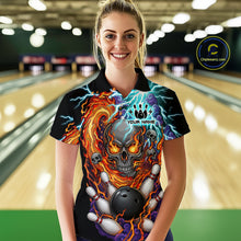 Load image into Gallery viewer, Woman wearing a black bowling polo featuring a flaming skull graphic, lightning effects, bowling pins, and a black bowling ball, with custom name text.