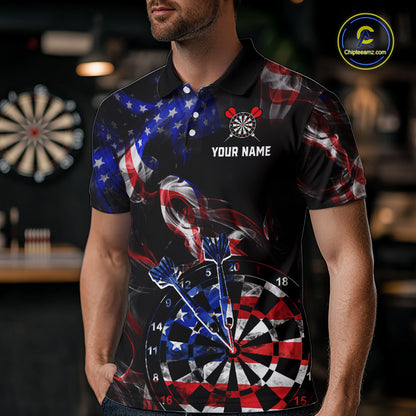 Man wearing a black darts polo featuring patriotic American flag smoke graphics, dartboards, blue darts, and custom team and player name text.