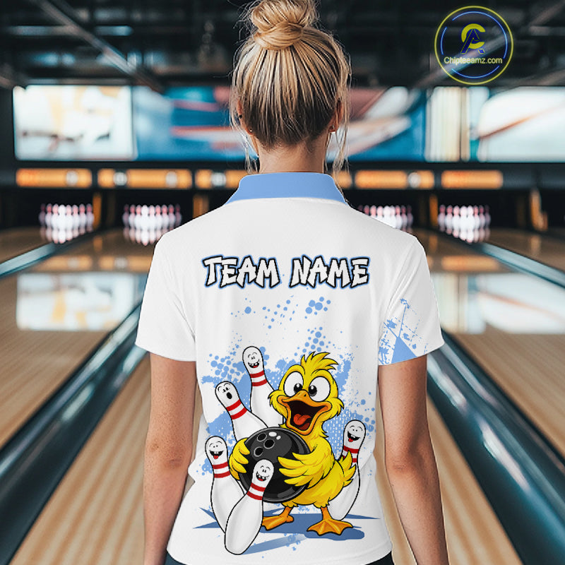 A woman viewed from behind wearing a white bowling-themed polo shirt with a blue collar and a large cartoon duck graphic on the back. The shirt features the text 'TEAM NAME' and a yellow duck holding bowling pins and a bowling ball, set against bowling lanes in the background.