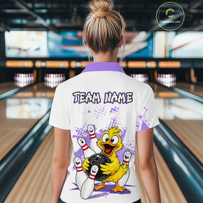 A woman viewed from behind wearing a white bowling-themed polo shirt with a purple collar and a large cartoon duck graphic on the back. The shirt features the text 'TEAM NAME' and a bowling scene with pins, bowling balls, and purple splatter details.