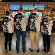 Load image into Gallery viewer, Four people wearing beige and black darts polo featuring a bald eagle, torn-flag graphics, dartboard designs, and custom team text.