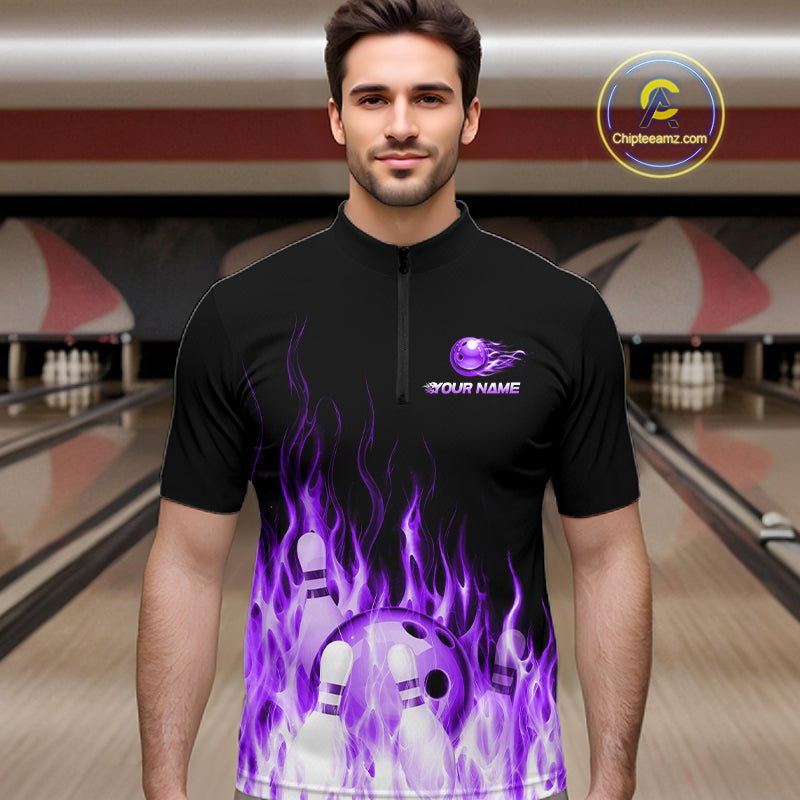 Man wearing a black bowling shirt with purple flames and a bowling ball design in a bowling alley.