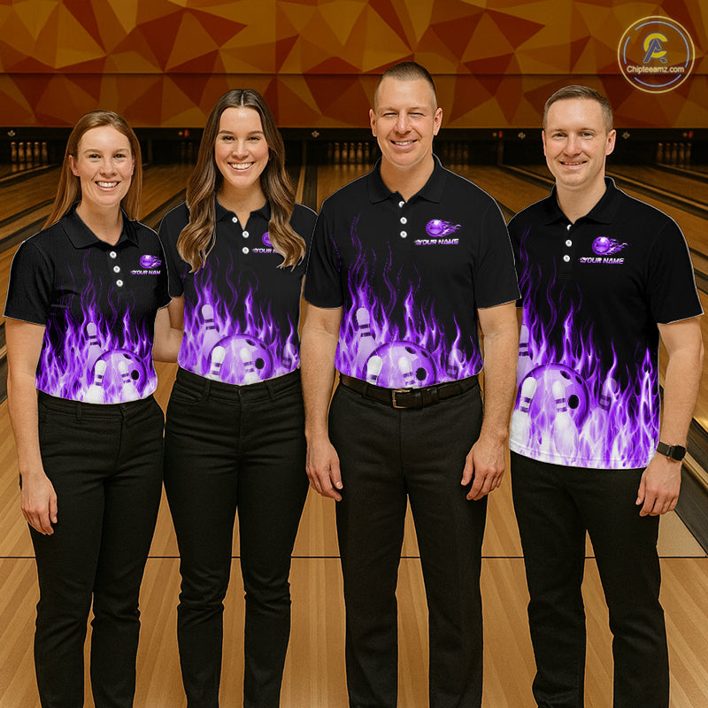 Four people wearing matching black polo shirts with a purple flame design on a bowling alley.