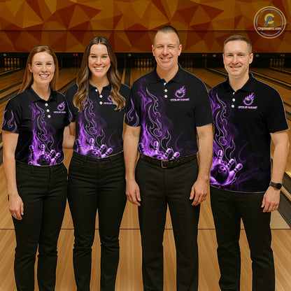 Four people standing in a bowling alley wearing matching black short-sleeve polo shirts with purple flame and bowling-pin graphics, paired with black pants. 