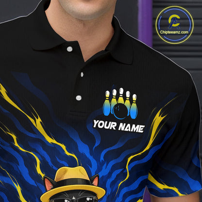 A close-up of a person wearing a black short-sleeve polo shirt with a bowling-themed graphic. The design features blue and yellow flame-like swirls, a bowling pins graphic, the text 'YOUR NAME', and a cartoon cat in a yellow hat at the bottom.