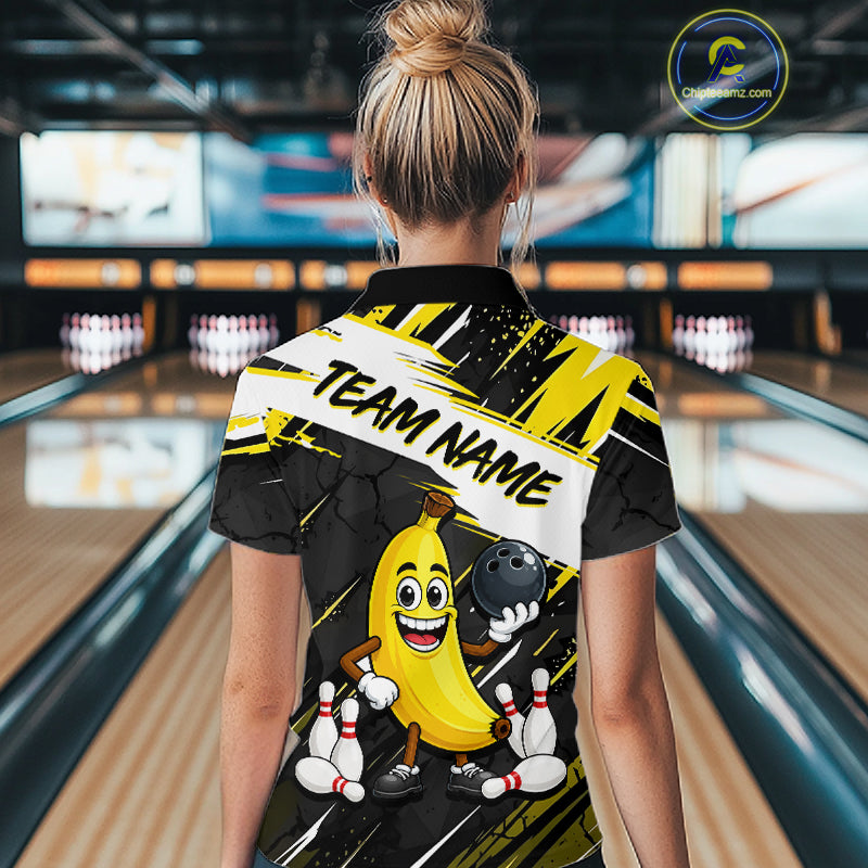 Women wearing a bowling-themed shirt with a cartoon banana character in a bowling alley.