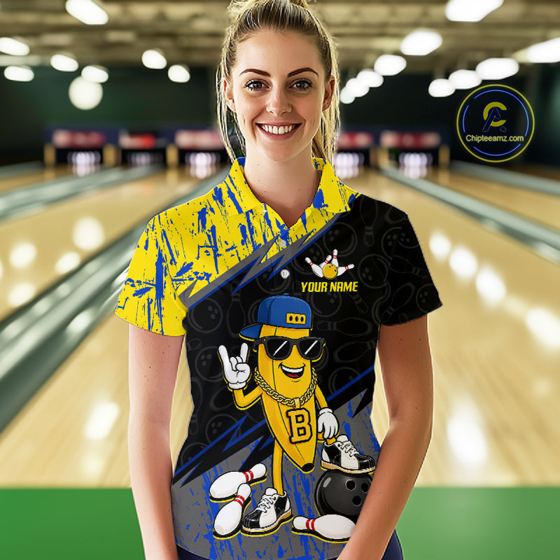 Women polo wearing a colorful bowling shirt with a cartoon character in a bowling alley.