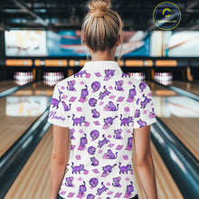 Load image into Gallery viewer, Woman wearing a white shirt with purple cat pattern in a bowling alley.