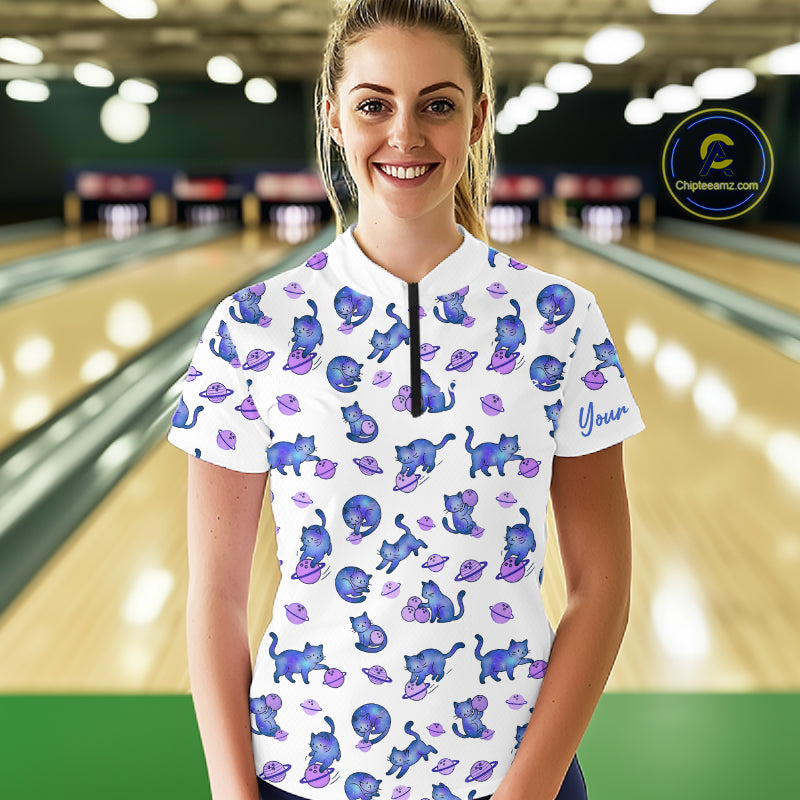 Woman wearing a white shirt with blue cat pattern in a bowling alley