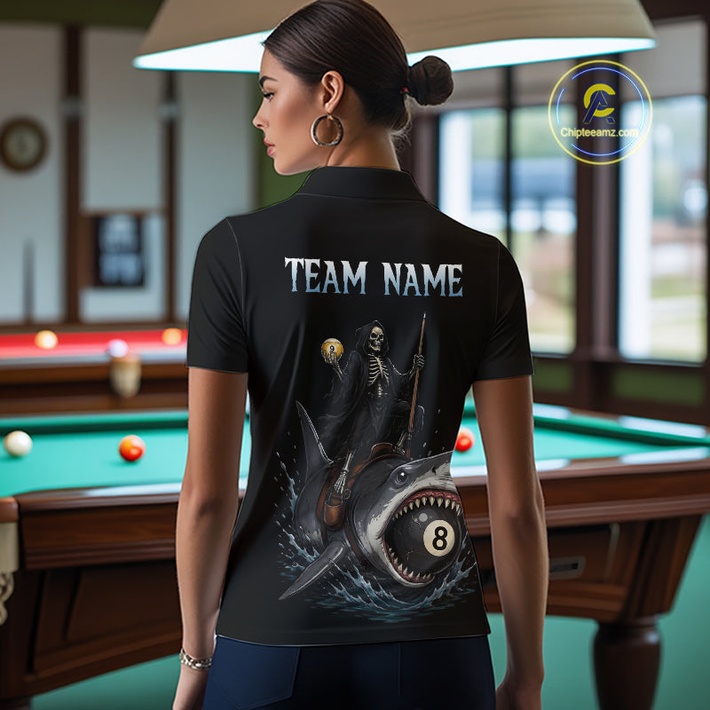Woman wearing a black t-shirt with a graphic design and 'TEAM NAME' text in a pool hall.