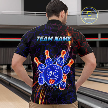 Man standing in a bowling alley wearing a black neon-style bowling quarter zip shirt with a glowing blue cartoon bowling ball mascot, fiery orange pin graphics, and custom team name text.