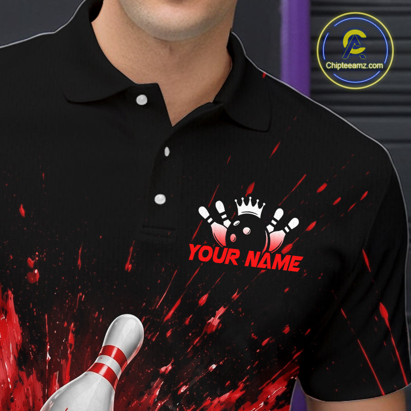 Man wearing a black bowling quarter zip shirt with dramatic red splatter graphics, a large black bowling ball, and flying pins, plus custom player name text.