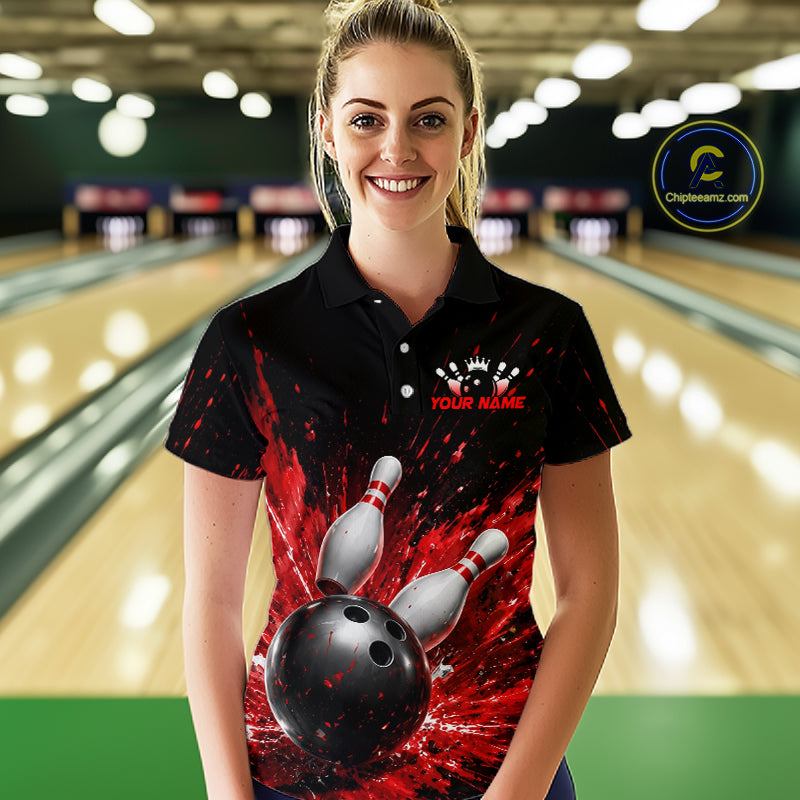 Woman wearing a black bowling polo shirt with dramatic red splatter graphics, a large black bowling ball, and flying pins, plus custom player name text.