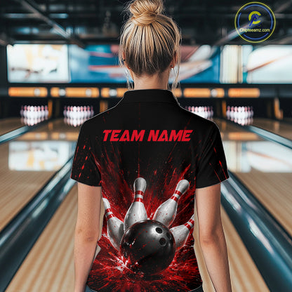 Woman wearing a black bowling quarter zip shirt with dramatic red splatter graphics, a large black bowling ball, and flying pins, plus custom team name text.