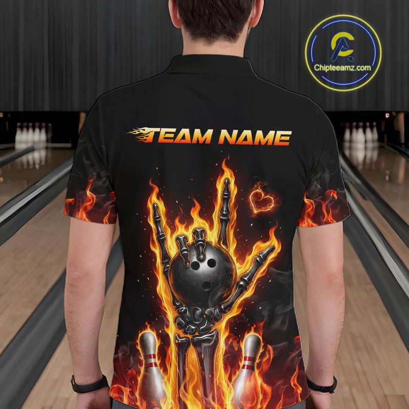 A person viewed from behind wearing a black short-sleeve polo shirt with a large bowling-themed graphic on the back. The design shows a skeleton hand holding a bowling ball with flaming fingers, bowling pins, and the text 'TEAM NAME' across the upper back.