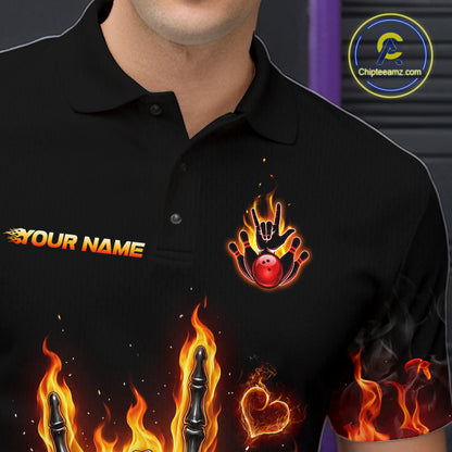 A black polo shirt with custom graphic designs, including a flame-and-hand logo with a red bowling ball and a customizable name text print, shown on a model.